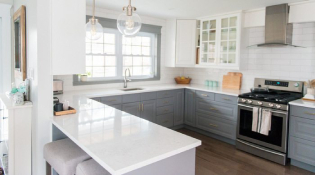 https://www.advancedresurfacingllc.com/wp-content/uploads/2019/10/A-gray-and-white-kitchen-makeover-using-IKEA-cabinetry-quartz-countertops-subway-tile-and-gold-hardware.jpg
