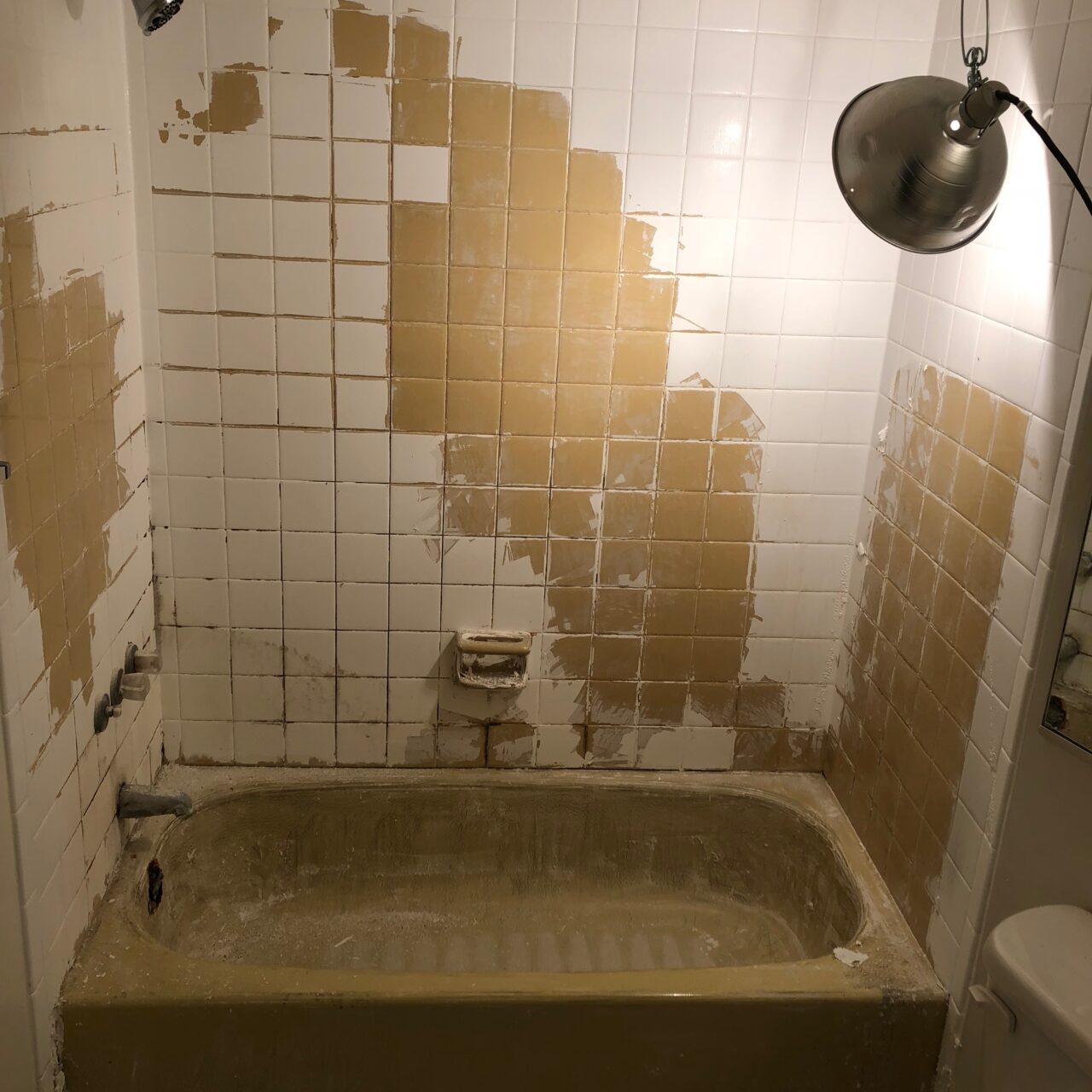 A bathtub and shower with stained surfaces
