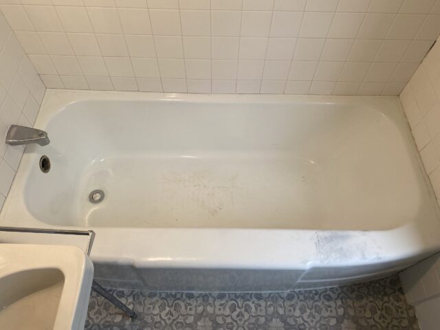 A bathtub with dirt stains