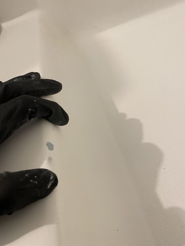 photos of inside bathtub with gloved hand